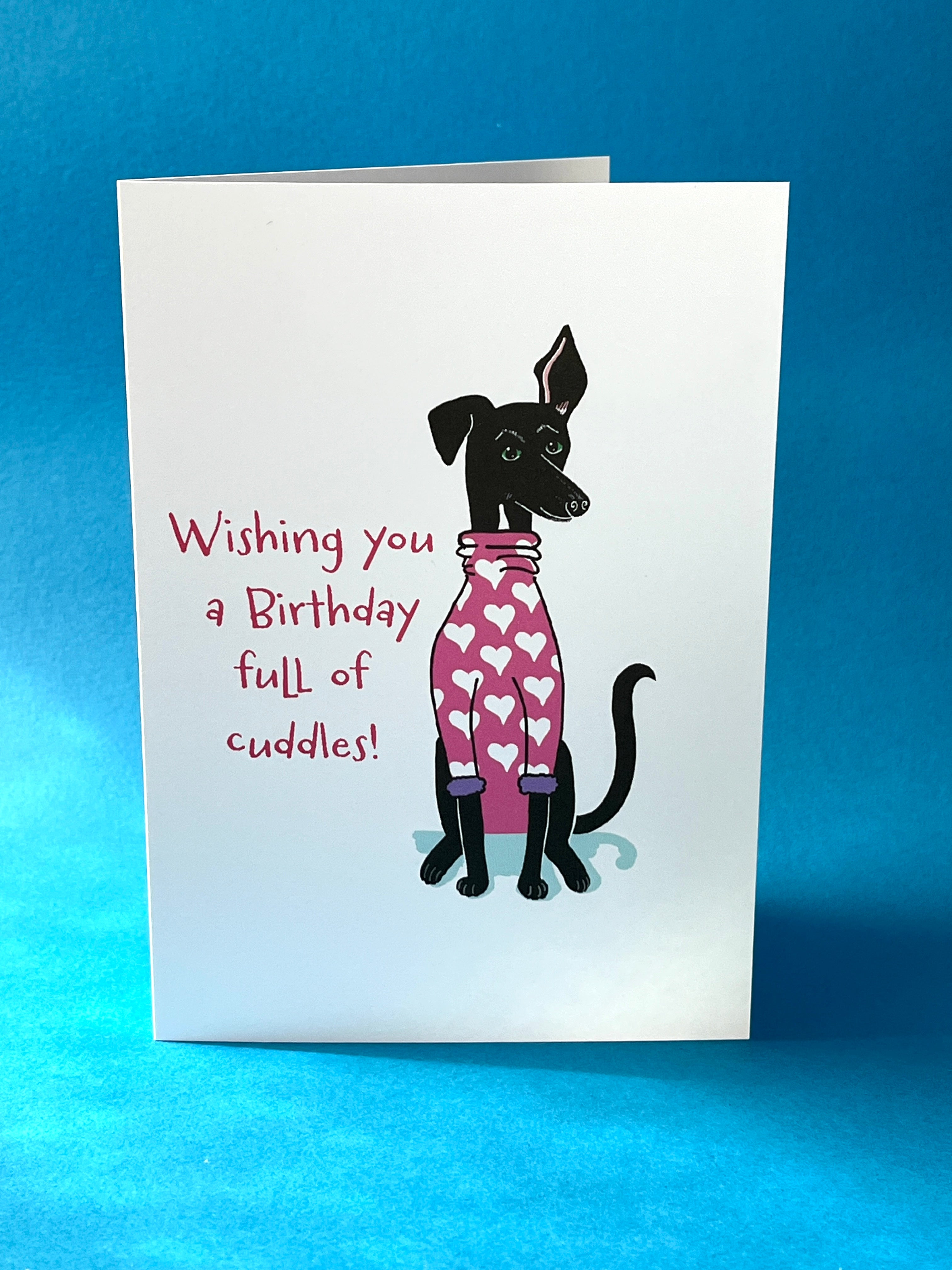 Greeting card with a dog illustration and birthday message on a blue background