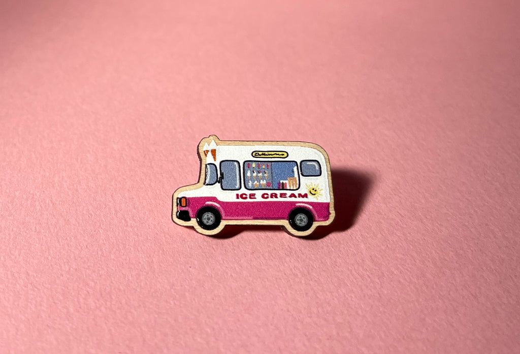 Pin of an ice cream truck on a pink background