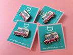 Four ice cream van pins on blue cards with a pink background