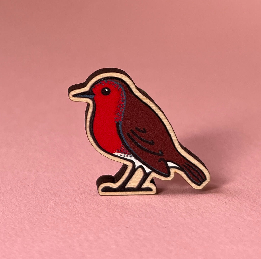 Bird-shaped pin on a pink background