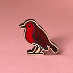 Bird-shaped pin on a pink background
