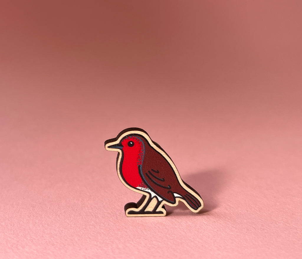 Robin pin on a pink background