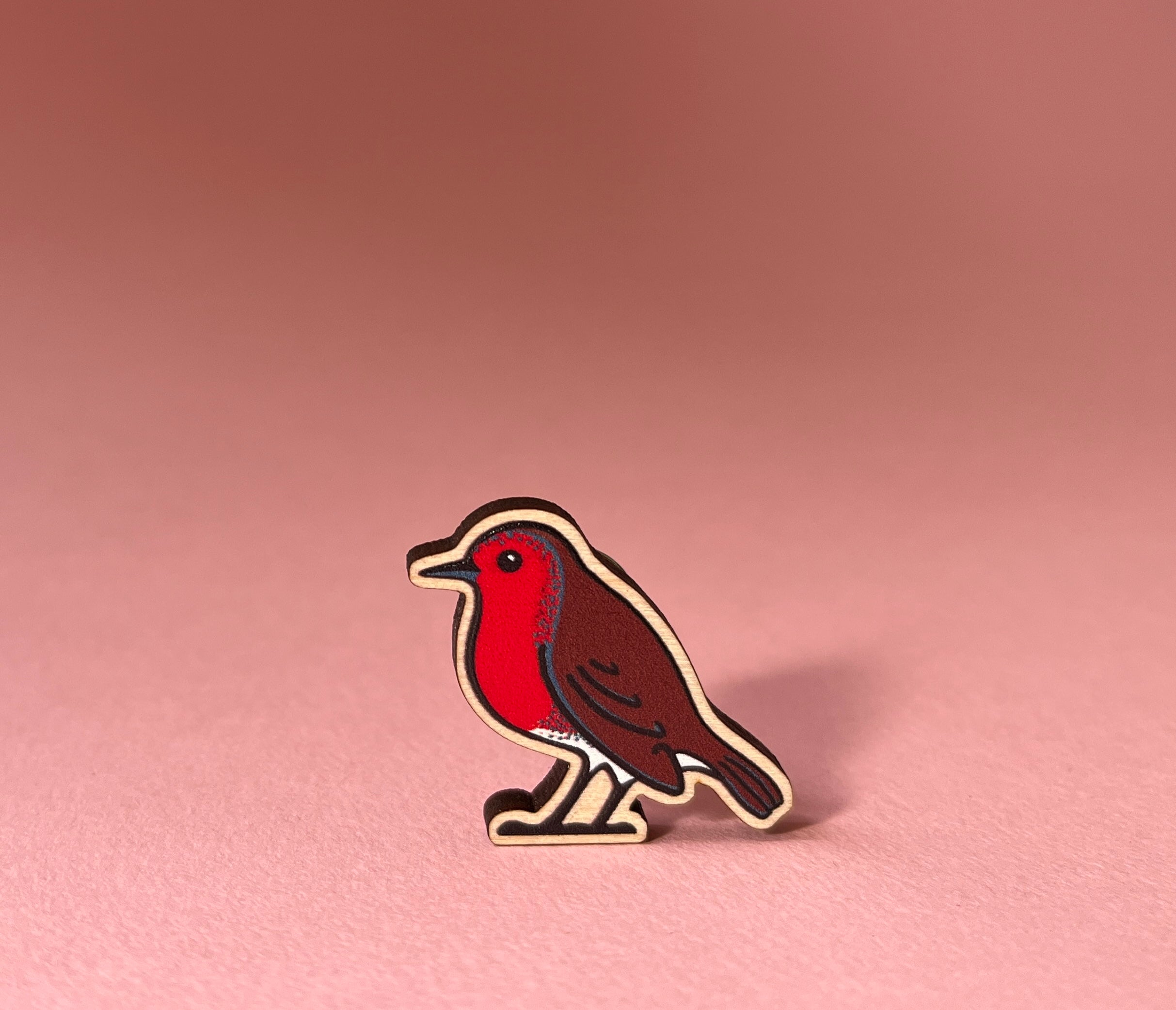 Robin pin on a pink background
